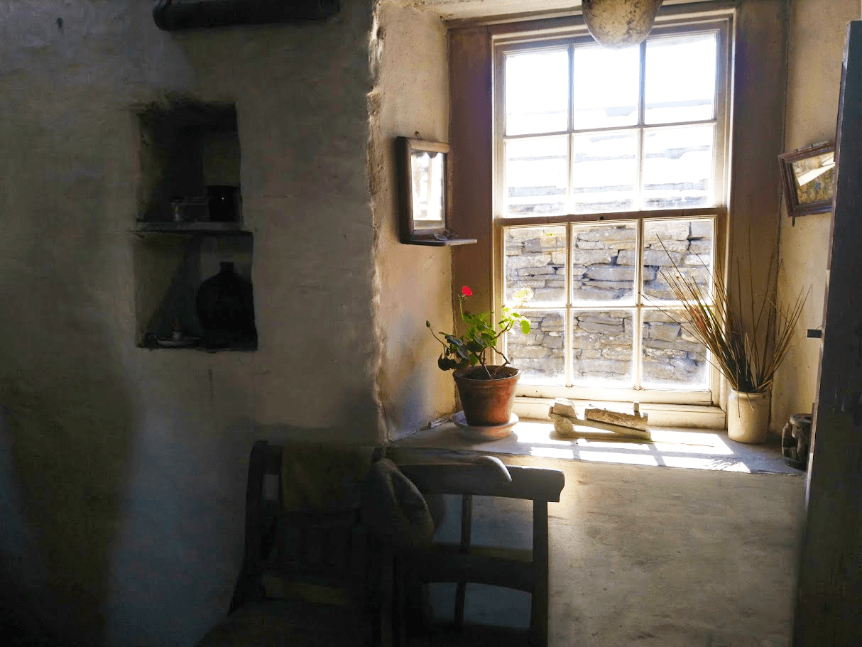 sun streaming through the farmhouse window of Corrigall Farm Museum 